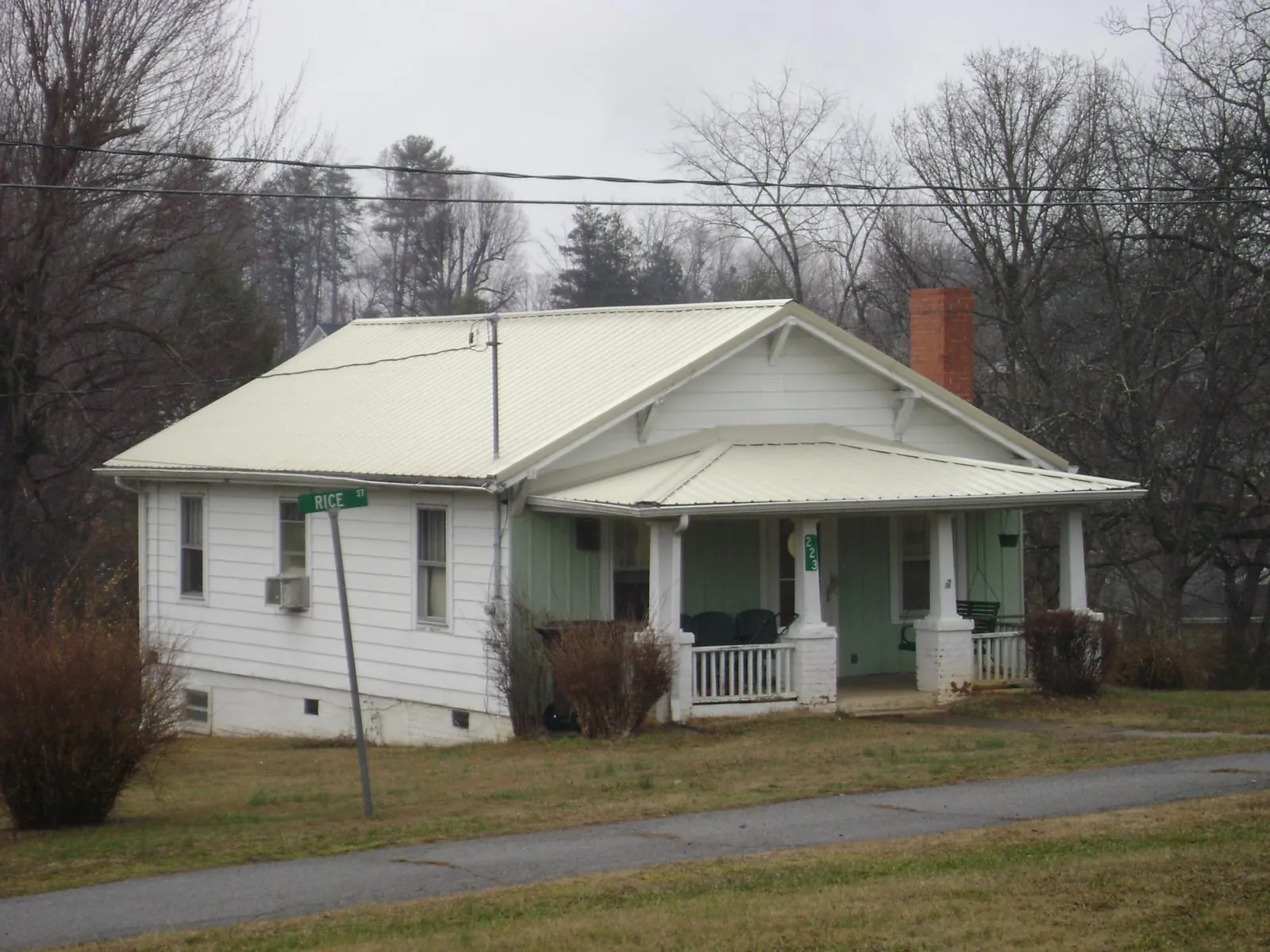 White metal roof on a craftsman bungalow at a street corner in Groveland
